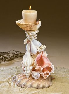 a candle that is sitting on some shells