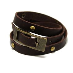 "Narrow stylish leather bracelet in two turns around the arm. Suitable for both girls and guys who like vintage style.  The length of the bracelet is decorated with domed rivets, and the length is regulated by a large buckle, which itself appears as a decorative element.  Made of genuine leather in a single layer with a thickness of about 2 mm.  All bracelet variants are supplied with antique bronze color fittings.  Tech info ----------------- Length: 40-50 cm long (15,5-19,6\") Base width: 11 mm  Thickness: approx. 2 mm   Our other goods -------------------- Aviator cuff bracelet https://www.etsy.com/listing/678376987/aviator-cuff-oldschool-design-double Long strap watch https://www.etsy.com/listing/1013857794/noir-minimalist-quartz-calendar-watches Matte black watch https://www.etsy.com/ Adjustable Brown Jewelry With Antique Buckle, Adjustable Brown Leather Bracelet With Belt Detail, Adjustable Brown Leather Belt Bracelet, Vintage Leather Bracelet With Rivets, Vintage Leather Bracelets With Rivets, Vintage Adjustable Leather Bracelet With Rivets, Adjustable Vintage Leather Bracelet With Rivets, Vintage Brown Adjustable Wrap Bracelet, Adjustable Brown Leather Bracelet With Brass Hardware