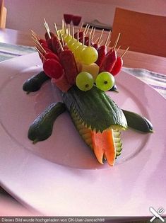 a white plate topped with fruit and veggies