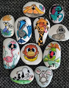 several painted rocks with different animals on them