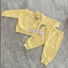 Matching Light Yellow Sweatsuit Set, 73 Cm, Brand New Condition With Tags Still Attached. Top Has Detachable Teddy Bear Head Pin On Lapel. X2 Piece Set Includes Matching Long Sleeve Top + Bottoms. Casual Solid Color Playtime Set, Matching Long Sleeve Playwear Sets, Playful Solid Color Cotton Sets, Playful Yellow Long Sleeve Sets, Cute Yellow Onesie For Loungewear, Cute Solid Color Playwear Sets, Yellow Cotton Matching Set, Yellow Long Sleeve Matching Set, Yellow Matching Sets For Loungewear