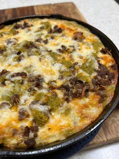 a close up of a pizza in a pan on a table