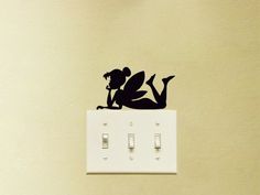 a wall mounted light switch with a silhouette of a mouse on it's side