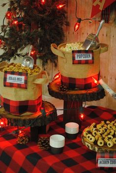 a table topped with lots of food next to a christmas tree