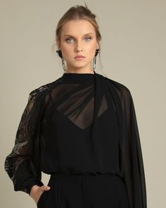 Elegant Embellished Tops For Workwear, Chic Tops With Sheer Sleeves For Cocktail, Chic Tops With Sheer Sleeves For Cocktails, Chic Cocktail Top With Sheer Sleeves, Elegant Black Embroidered Tops, Elegant Tops With Embroidered Sleeves For Work, Elegant Embroidered Sleeve Top For Work, Long Sleeve Tops With Embroidered Sleeves For Work, Fitted Black Top With Embroidered Sleeves