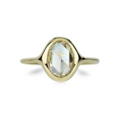 a gold ring with an oval cut stone in the center