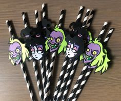 black and white striped paper straws with cartoon characters on them