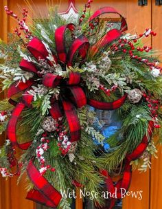 a red and black wreath on the front door