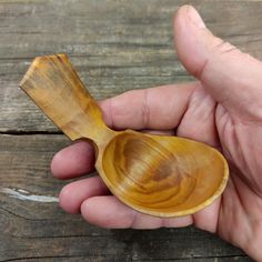 a person holding a wooden spoon in their hand