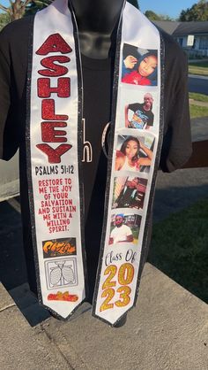 a person wearing a black shirt and white scarf with pictures on it that say, class of'28