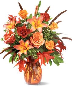 a vase filled with lots of orange and red flowers