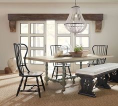 a dining table with four chairs and a bench in front of it on the carpeted floor