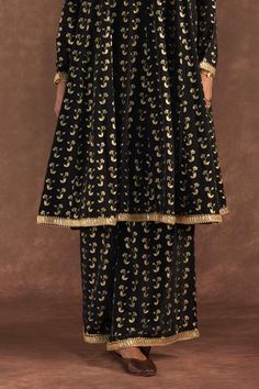 Black anarkali with all-over springbud foil prints. Comes with culotte and dupatta with embroidered border and kinari.
Components: 3
Pattern: Foil Printed, Embroidered
Type Of Work: Springbud
Neckline: Round
Sleeve Type: Full
Fabric: Anarkali and Culotte- Crepe Silk, Dupatta- Organza
Color: Black
Other Details: 
Disclaimer: The actual print-placement and colour of the product may vary slightly from the image shown.
Occasion: Sangeet - Aza Fashions Black Anarkali, Foil Prints, Types Of Work, Embroidered Border, Silk Dupatta, Print Placement, Foil Print, Set For Women, Anarkali