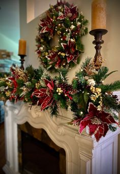 two wreaths are hanging on the fireplace mantel