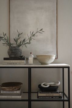 a table topped with books and a bowl