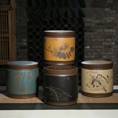 four canisters sitting on top of a table