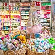 two baskets filled with balls of yarn next to each other in front of a store