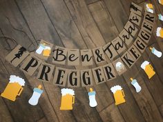 a banner with beer mugs hanging from it's sides on a wooden floor