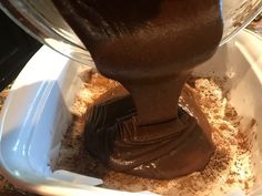 chocolate being poured into a white bowl