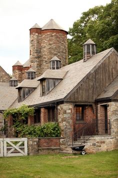 an old brick house with two towers and a gate