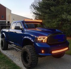 a large blue truck parked in front of a building