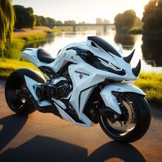 a white motorcycle parked on the side of a road next to a body of water