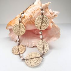 This lightweight statement necklace elegantly combines the luminous beauty of freshwater pearls with the earthy beauty of hand woven rattan. A double strand of waxed cotton knots 12 pearls in place. A piece of organic luxury that will elevate any ensemble. The magnetic closure makes it a snap to put on and remove. The rattan circles are about 1.75". The length of the necklace open is 21". If you would like a shorter version, just leave a note. Add this to your vacation wardrobe today! Earthy Beauty, Organic Luxury, Vacation Wardrobe, Woven Rattan, Waxed Cotton, Magnetic Closure, Stone Jewelry, Hand Woven, Fresh Water