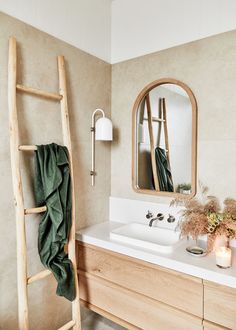 a bathroom with a ladder, sink and mirror