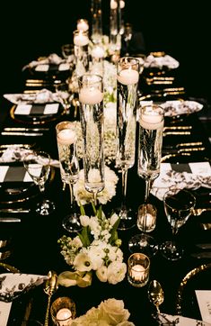 a long table is set with candles and flowers for an elegant dinner or party event