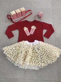 a child's costume made out of popcorn kernels and other items on the floor