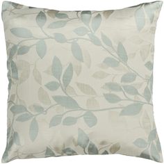 a white pillow with blue leaves on it