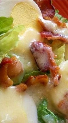 a close up of a plate of food with bacon and lettuce