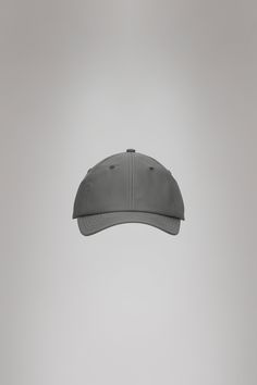 Cap is Rains' take on the classic baseball cap with 6 panels and curved brim. The Cap is characterized by a curved brim and six-paneled design held in place by a back-mounted adjustable webbing strap and buckle. It features eyelets to ensure ventilation for breathable comfort. Cap is cut from Rains' signature PU fabric. The finish is lightweight with a smooth feel. Adjustable Sporty Baseball Cap With Curved Visor, Classic Adjustable Dad Hat With Curved Visor, Classic Adjustable Baseball Cap With Curved Brim, Outdoor Snapback Hat With Curved Visor, Classic Baseball Cap With Adjustable Fit And Curved Brim, Adjustable Baseball Cap With Curved Visor, Classic Curved Visor Baseball Cap For Outdoor, Classic Outdoor Baseball Cap With Curved Visor, Classic Baseball Cap With Adjustable Fit And Curved Visor