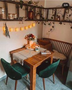 a wooden table with two green chairs around it