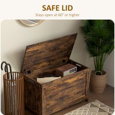 an open wooden box sitting on top of a table next to a potted plant