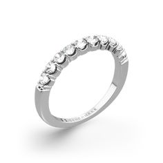 a white gold ring with five stones on the side, set in 18k white gold