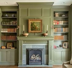 a living room filled with furniture and a fire place in front of a bookshelf