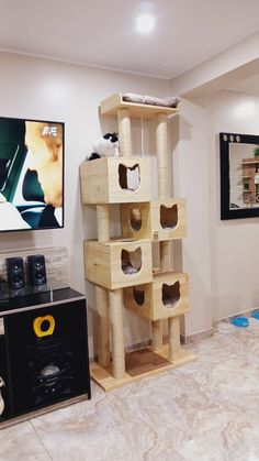 a cat tree in the middle of a living room