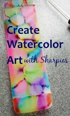 a bookmark with the words create watercolor art with shapes on it and a brush next to it