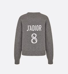 The gray boxy cashmere sweater refers to Christian Dior's lucky number. A 'J'ADIOR 8' inscription in white jacquard highlights the back, and the ribbed hem and cuff showcase a classic athletic look. The crew-neck sweater pairs easily with a tulle skirt for a timeless look..