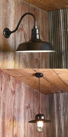 two lights hanging from the side of a wooden wall next to a light fixture on a wood paneled wall