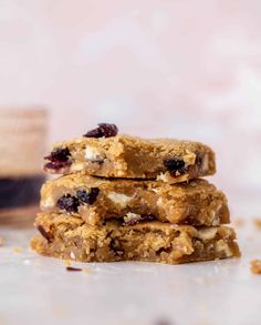 three bars stacked on top of each other with cranberries and nuts in the middle