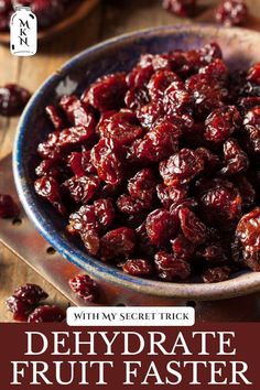 a bowl filled with dried cranberries on top of a wooden table