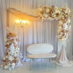 a white couch sitting next to a table covered in flowers