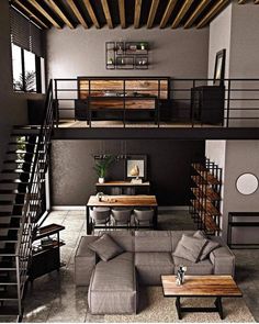 a living room filled with furniture next to a stair case in a loft style home