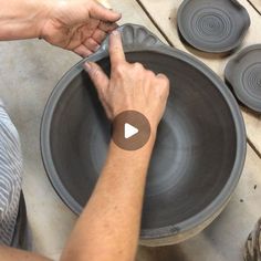 a person is making a bowl out of clay