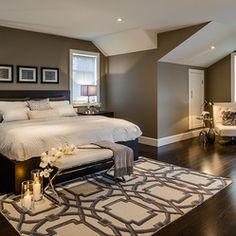 a large bed sitting in the middle of a bedroom