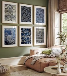 a living room filled with furniture and pictures on the wall above it's coffee table