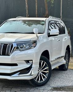 a white suv parked on the side of a road