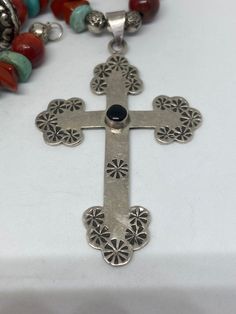 "This piece is so beautiful. It is a genuine, vintage, Taxco multi stone and sterling silver cross necklace. The necklace is 22 inches. The necklace features gorgeous, natural blue turquoise, red coral, carnelian, black onyx and sterling silver beads with a huge stamped sterling silver and black onyx cross. The stones are nuggets, round beads, rondelle beads. The sterling silver beads are stunning with etchings, including flowers, scrollwork, ribbed and other designs; some beads are shaped like Southwestern Silver Cross Pendant Necklace, Southwestern Style Silver Cross Pendant Necklace, Southwestern Silver Cross Jewelry, Southwestern Style Silver Cross Necklaces, Southwestern Style Silver Cross Necklace, Handmade Southwestern Cross Necklace, Southwestern Handmade Cross Necklace, Southwestern Silver Cross Necklace, Silver Bohemian Cross Necklace